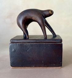 a bronze statue of a dog standing on its hind legs