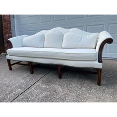 a white couch sitting in front of a garage door