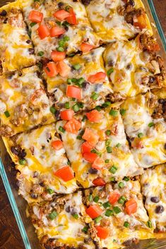 a casserole dish filled with meat, cheese and veggie toppings