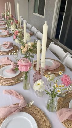 the table is set with pink napkins and white plates