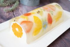 a white plate topped with sliced fruit on top of a wooden table