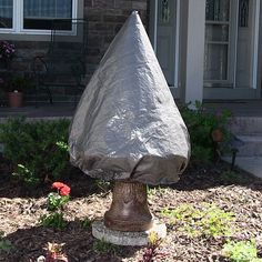 a fire hydrant covered with a tarp in front of a house