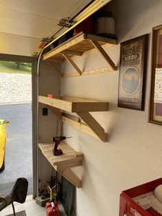 the inside of a garage with shelves and tools