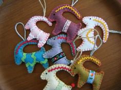 several stuffed animals are hanging from strings on a table