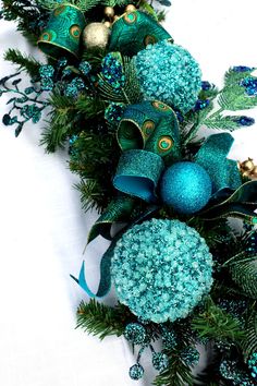 an arrangement of blue and green christmas decorations