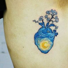 a heart tattoo on the side of a woman's stomach with flowers growing out of it