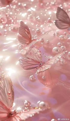 some pink butterflies are flying in the air with water droplets on them and bubbles around them