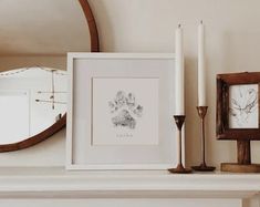 a white mantle topped with pictures and candles