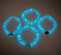 This glow in the dark bracelet is designed using 8mm crystal glass beads and one 10mm  lamp work glass bead in the center of the bracelet.  This bracelet will appear transparent in the daylight.  Expose it to bright light for a few minutes and it will glow when you enter a dark room or outside at night.  The longer you expose your jewelry to bright light the longer and brighter you will  enjoy the glow! In the dark your bracelet will simply amaze you!    This piece is offered in clear with your Glow In Dark Bracelet, Glow In The Dark Bracelets, White Luminous Beaded Bracelets For Gifts, Neon Beaded Bracelets As Gift, Dark Bracelet, Outside At Night, Glow Bracelets, Glow Jewelry, A Dark Room