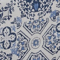 an intricate blue and white design on fabric