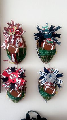 three football ornaments are hanging on the wall