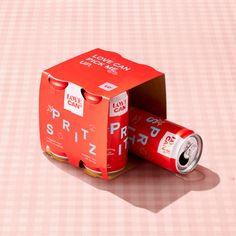 two cans of soda sitting on top of a table