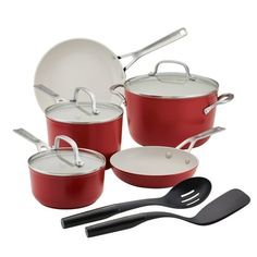 an assortment of red pots and pans with utensils next to each other