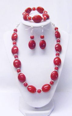 "Red Oval/Round Acrylic w/Wavy Rhinestone Bead Necklace/Bracelet/Earrings This necklace set is made with big, beautiful, red oval acrylic beads, 10mm round acrylic beads and wavy Rondelle crystal rhinestones beads strung on flexible beading wire and finished off with silver chain. It us 21 ½\" in length and fastens with silver lobster clasp. It comes with bracelet and earrings that hang from silver fish hook ear wires. Necklace Length: 21 ½\" Earrings Length: 2 ½\" (including ear wires) Bracelet Chunky Bead Necklaces, Orange Wood, 2 Earrings, Purple Rhinestone, Chunky Beads, Rhinestone Bead, Wire Bracelet, Bead Stringing, Matching Bracelets