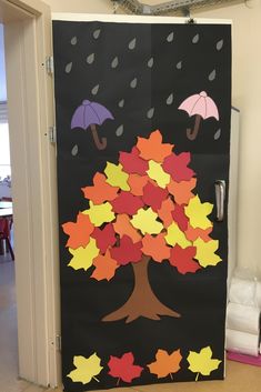 a door decorated with fall leaves and umbrellas