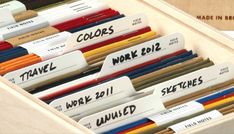 a drawer filled with lots of different colored pencils and paper labels that read colors work 2011