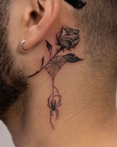 a man with a tattoo on his neck has a spider and rose behind the ear