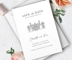 an elegant save the date card with pink roses and greenery next to it on top of two white envelopes