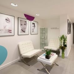 a living room filled with furniture and pictures on the wall