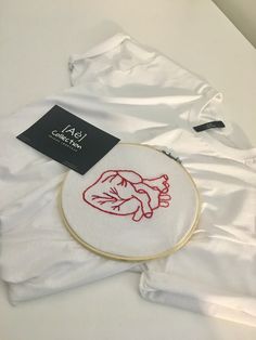 a white shirt with red embroidery on it