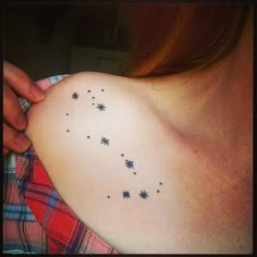 a woman's shoulder with stars on it and the word star written in black ink