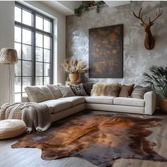 a living room filled with lots of furniture next to a large painting on the wall