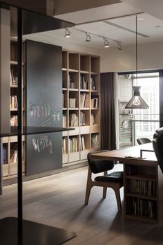 a dining room table with chairs and bookshelves