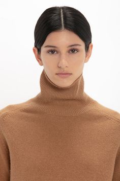 Luxury knitwear is a hallmark of the Victoria Beckham brand. Created in a sophisticated shade of Tobacco, this lambswool polo neck has a saddle shoulder design and contrasting ribbed neck and hemline. One of Victoria’s favourite pieces, the neckline can be folded over or worn upright for versatile styling options. A contrasting embroidered Victoria Beckham monogram adds a discrete design detail. Styled with the Jumbo Frame Belt In Burgundy Leather, Asymmetric Chino Trouser In Deep Mahogany and t Luxury Knit Polo Sweater With Collared Neckline, Luxury Brown Polo Collar Sweater, Luxury Elegant V-neck Sweater With Ribbed Collar, Luxury Women's V-neck Sweater With Ribbed Collar, Luxury Ribbed Collar V-neck Sweater, Chino Trousers, Polo Neck, Victoria Beckham, Design Details