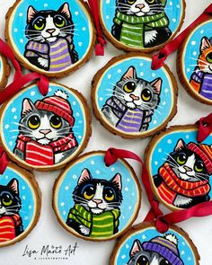 decorated cookies with cats wearing sweaters and hats