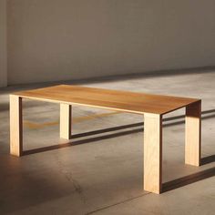 a wooden table sitting on top of a cement floor