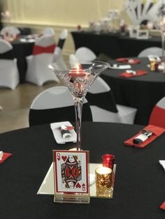 the table is set up with cards and candles