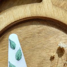 a pair of scissors sitting on top of a wooden table