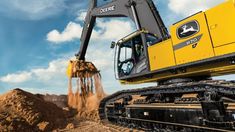 a yellow excavator digging dirt in the desert