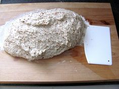 a loaf of bread on a cutting board with a knife