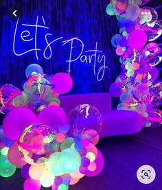 balloons and streamers in front of a party sign