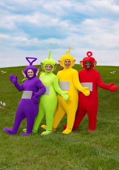 four people in costumes standing on the grass