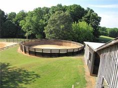 an aerial view of a fenced in horse pen