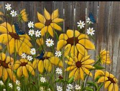 a painting of sunflowers and daisies in front of a fence with blue butterflies