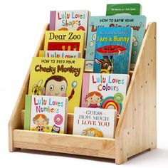 children's books are arranged in a wooden holder