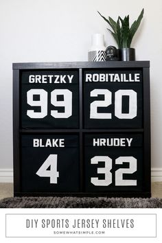 three black and white numbered boxes with numbers on them in front of a potted plant