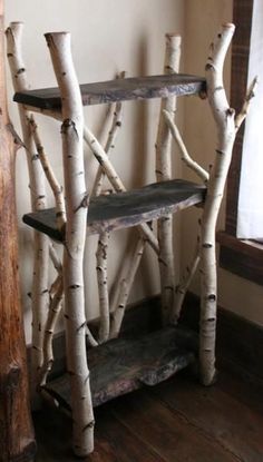 a shelf made out of branches in the corner of a room