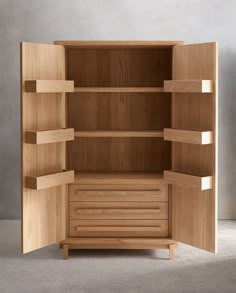 an open wooden cabinet with shelves and drawers