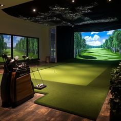 an indoor golf simulator is set up in the middle of a room