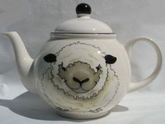 a tea pot with a sheep painted on it