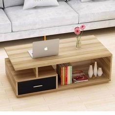 a coffee table with a laptop on it