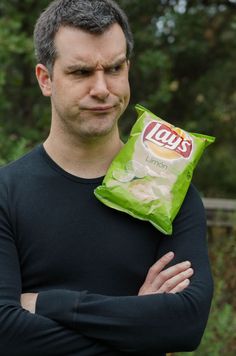 a man holding a bag of chips in his hands