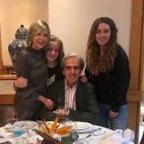 a family poses for a photo at the dinner table