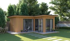 a small wooden building sitting on top of a lush green field