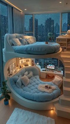 a room with bunk beds in the middle of it and stairs leading up to the second floor