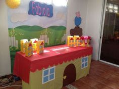 a table that has some food on top of it in front of a wall with a sign